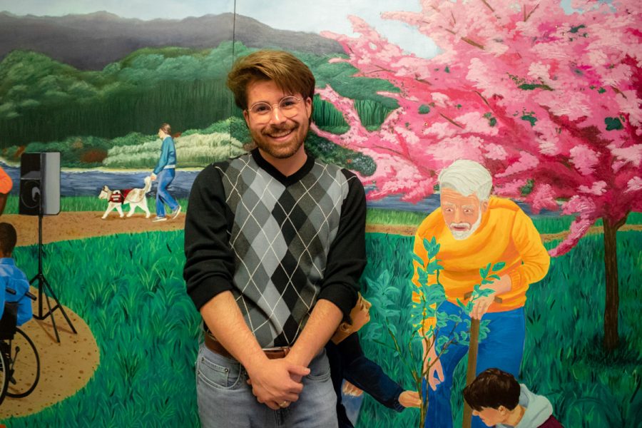 A new permanent art piece was revealed in Watkins Hall on Wednesday, March 1. The mural was painted by professor Alessandra Sulpys  contemporary studio practices class. Pictured above is Sean Merchlewitz, a third-year who helped paint the project. 