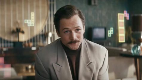 Jon S. Baird directs AppleTV+s new original movie, Tetris. The film follows the story of how one of the worlds most famous games came to the masses. Pictured above is Taron Egerton who plays Henk Rogers. 