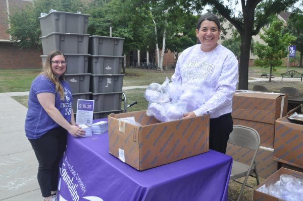 Opening up boxes with purple cotton candy, members of the WSU Giving Day group moves boxes to their booth in the WSU Courtyard before I ❤ WSU day on September 6th. 