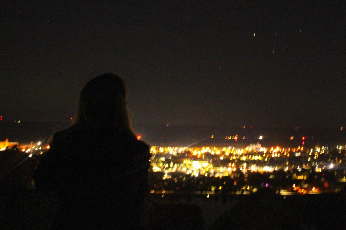 A college student looking at the night sky over Winona.