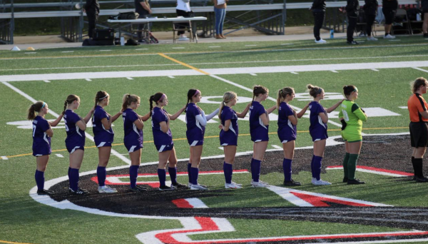 The starting line-up of the Winona State Women’s soccer team stands for The National Anthem. Contributed by Susie Dye.