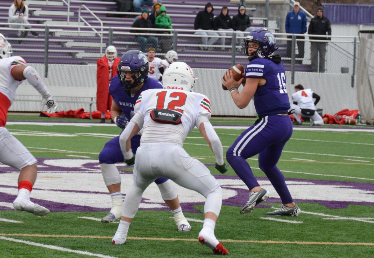 Third Year, Quarterback Cole Stenstrom faces off against a Minot State defensive player.