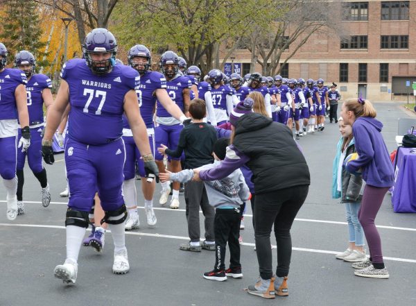 Noah Pappas high-fiving some
young fans during the Warrior walk.