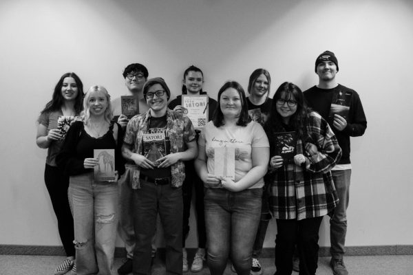 Satori staff takes an English course called “Projects in Writing” to work on the creation of the annual literary journal. Most of the staff is pictured above, holding previous editions of “Satori.” The staff gets the entirety of Spring semester to put together the journal and all of its moving parts and facets.