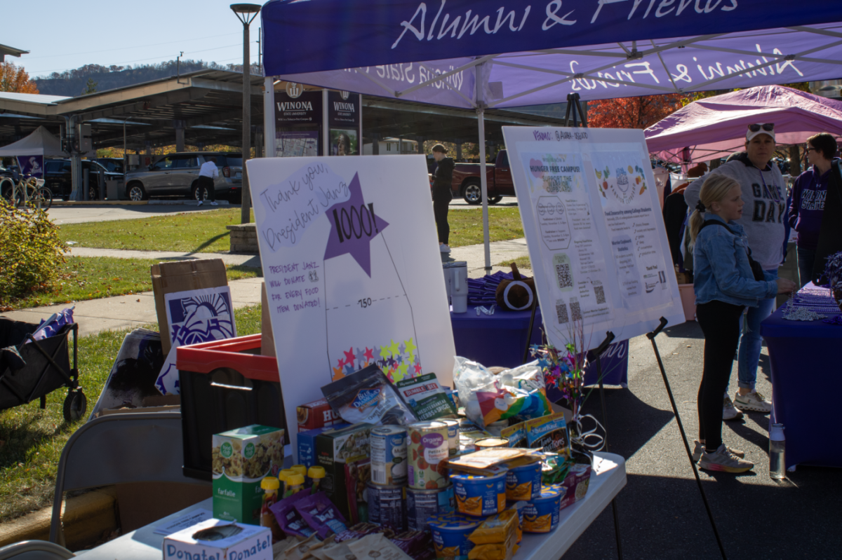 The Warrior Cupboard booth, set up at the Warrior Game Day Experience, collects donations to fill the Cupboard. 