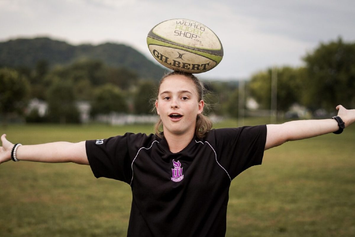 Captain Taryn Tom poses for a silly photo on the field where the rugby team practices.