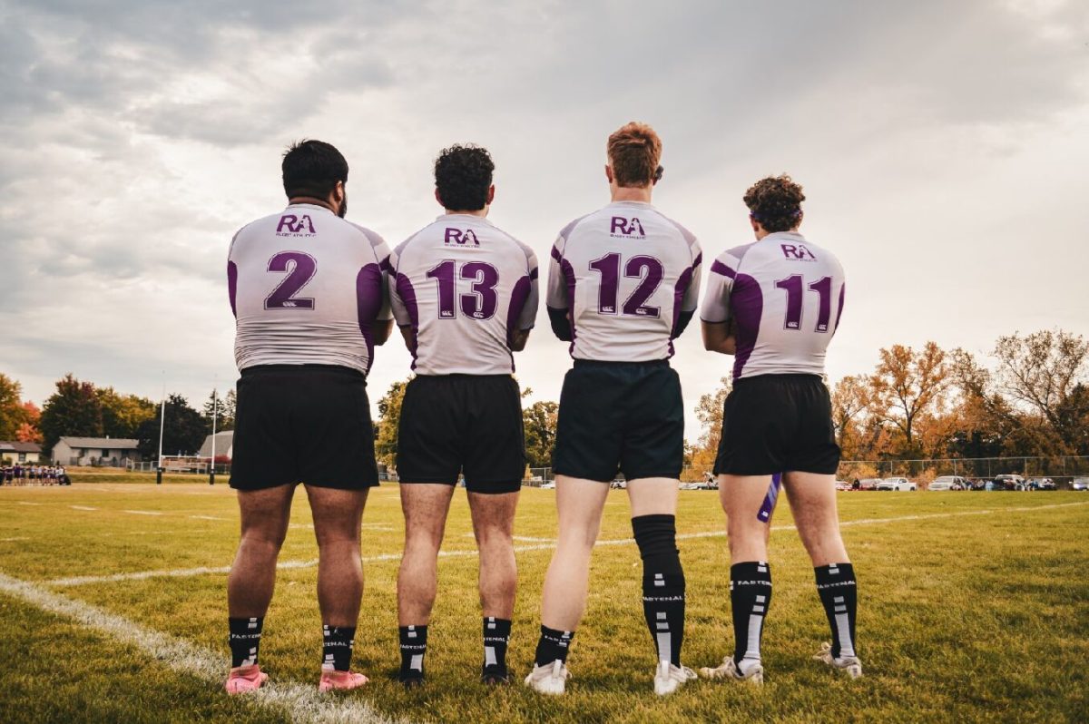 Four members of the WSU Dogg's stand before their playing field. 