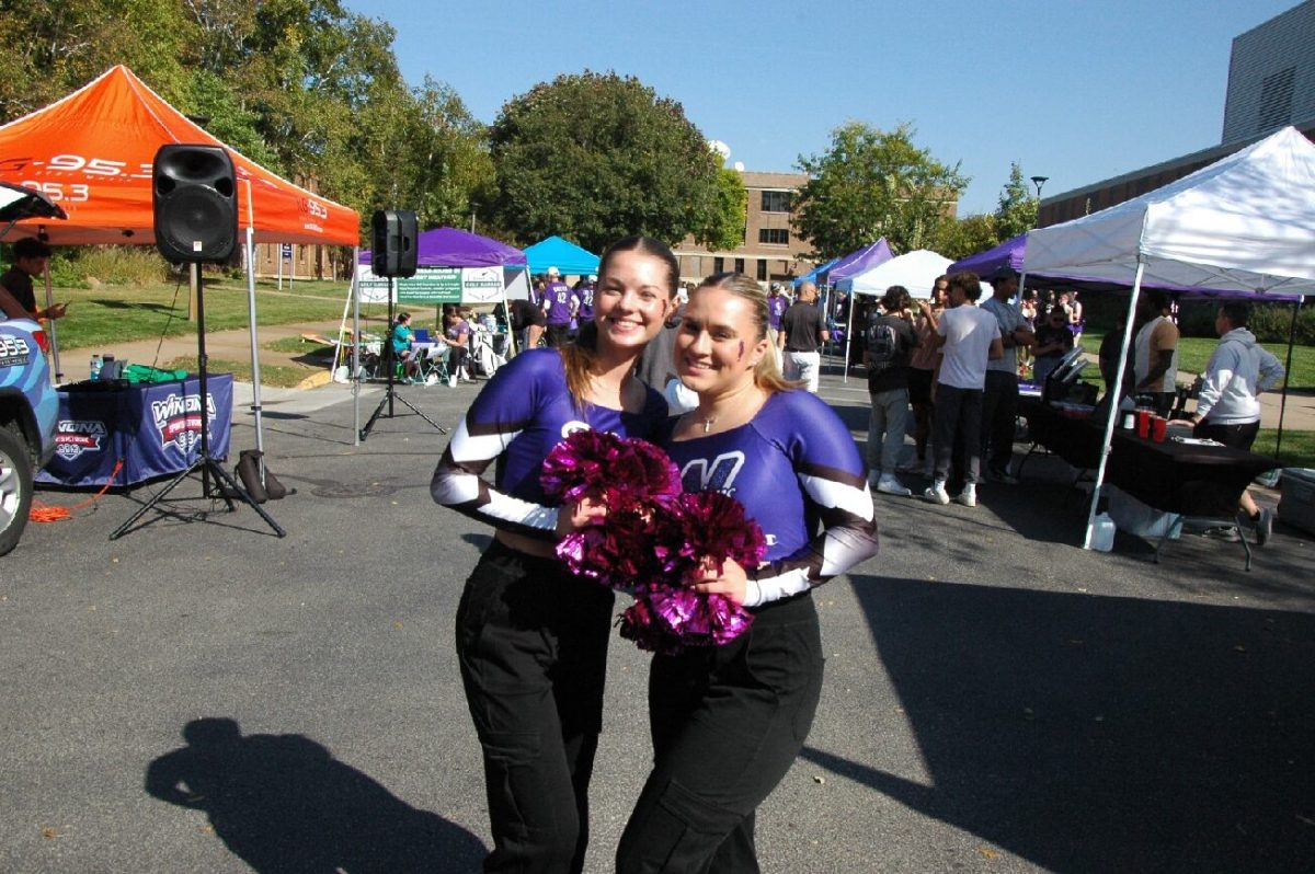 Dance Captains Avery Benda (left) and Sammie Mayo (right) showing their spirit at the Warrior Game Day Experience before Saturday’s football game. 