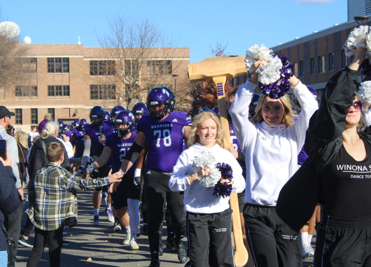 The warrior walk is an integral part of all warrior game day experiences. The dance and cheerleading team, the drum line and a police escort all lead the Winona State warriors to their home field.