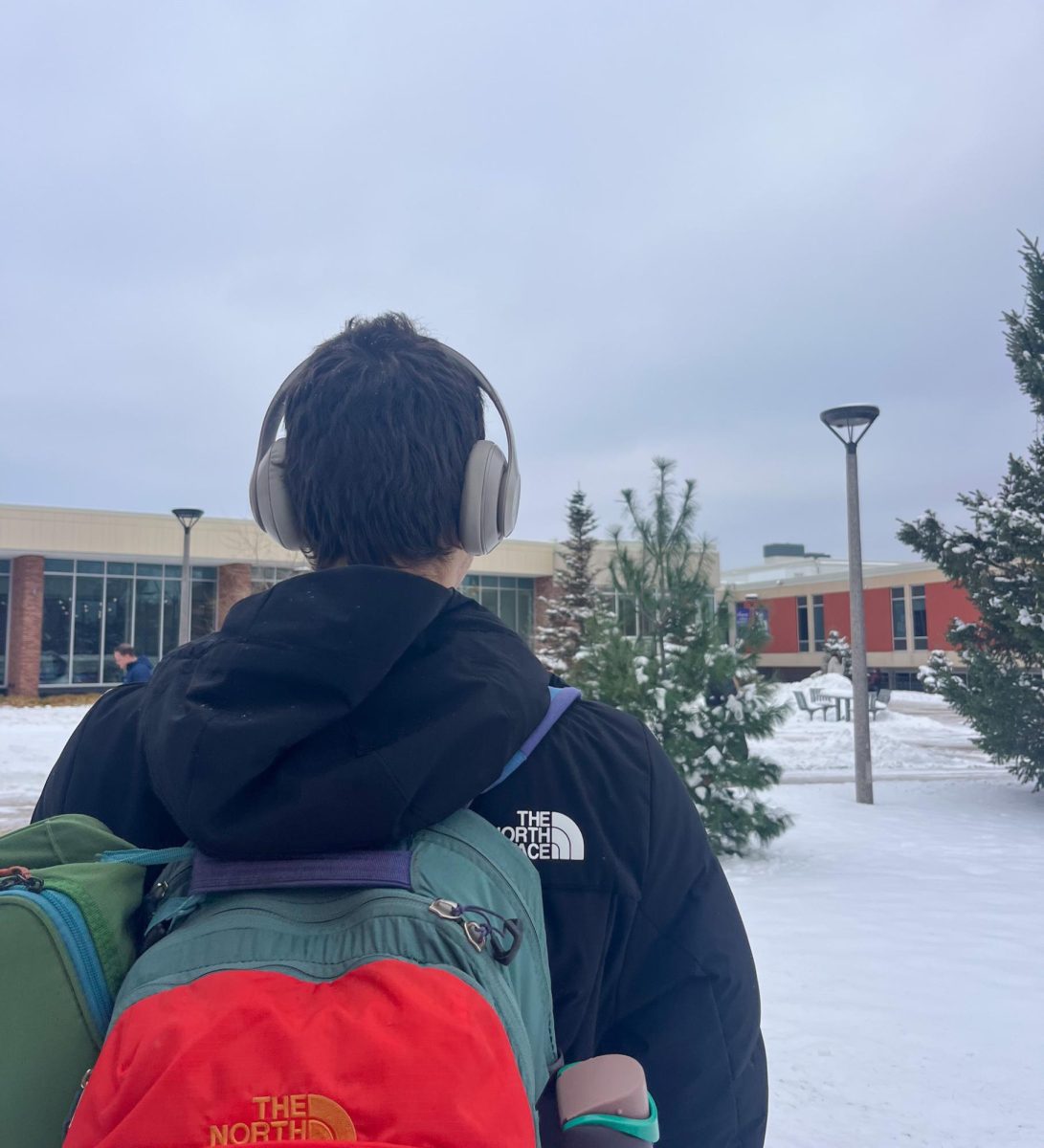 Winona State student getting into the Christmas spirit as he walks on campus.