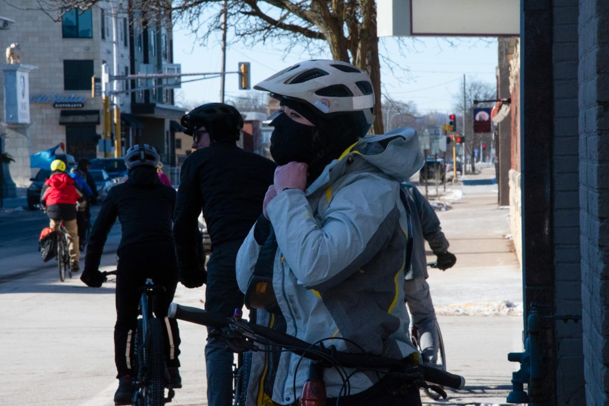A community member tightens their helmet strap as they prepare to join the memorial bike ride taking place not only in Winona, MN, but around the globe as well. 