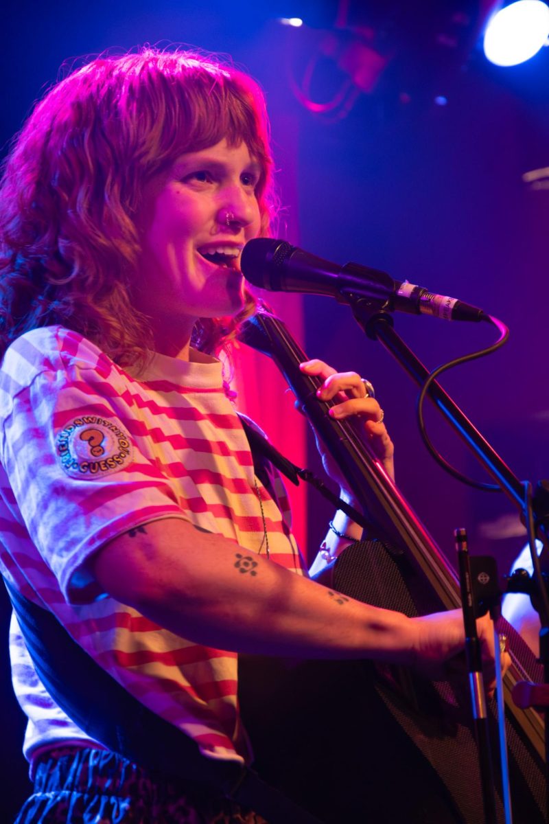 Bass player and vocalist, Victoria Elker from Good Morning Bedlam, continues their set after quickly realizing their set list was on a neighboring table in the bar. 